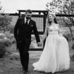 Wedding Photography in Osoyoos BC, a black and white portrait of a groom and bride walking together