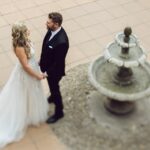 A bride and groom standing in front of each other by a fountain at Spirit Ridge in Osoyoos BC